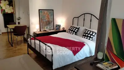 Stylish bedroom with modern decor and cozy ambiance in a contemporary apartment.