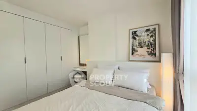 Elegant bedroom with cozy bed, built-in wardrobe, and stylish decor