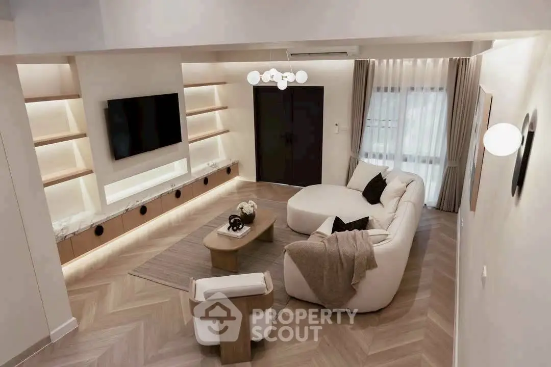 Elegant modern living room with stylish furniture and ambient lighting, perfect for relaxation and entertainment.
