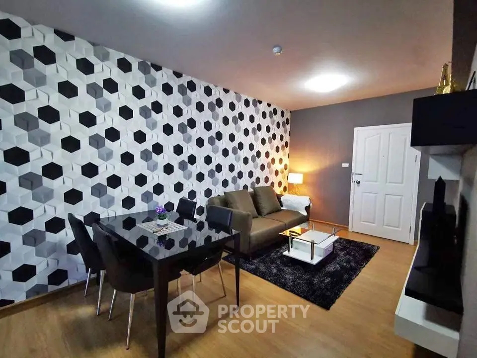 Modern living room with geometric wallpaper and sleek furniture