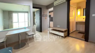 Modern apartment interior with open layout, featuring a cozy dining area and bright natural light.