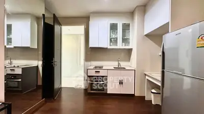 Modern kitchen with sleek appliances and dark wood flooring