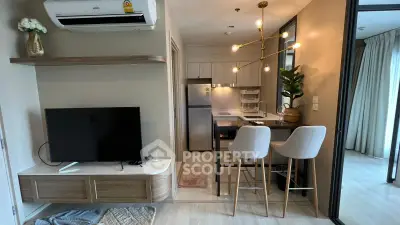 Modern open-layout kitchen and living area with stylish decor and natural light.