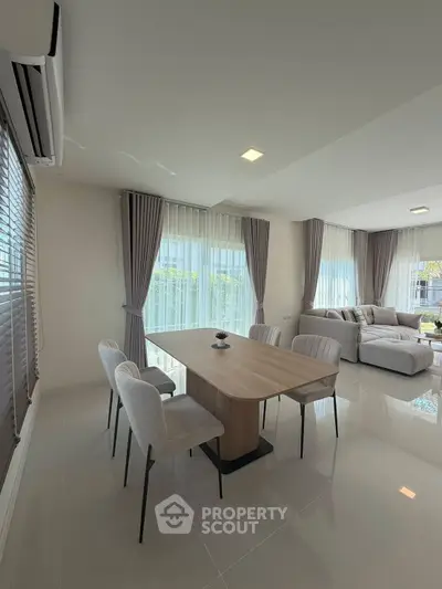 Spacious modern living room with elegant dining area and natural light