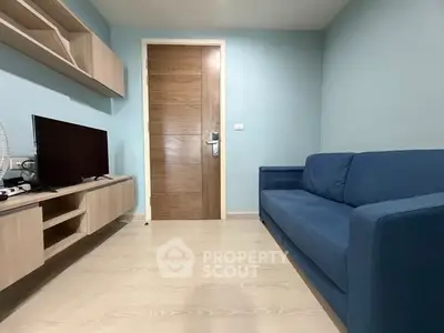 Modern living room with blue sofa and wooden TV stand