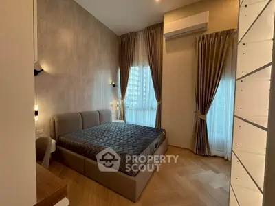 Modern bedroom with stylish decor and large windows for natural light