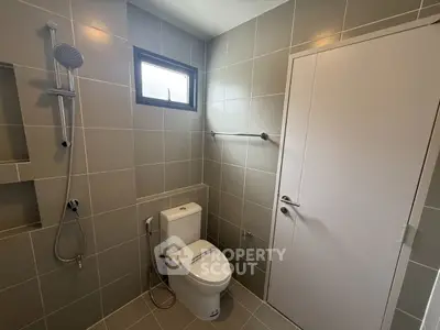 Modern bathroom with sleek gray tiles and contemporary fixtures.