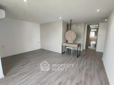 Spacious modern living room with sleek wooden flooring and minimalist decor