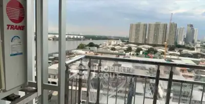 Stunning cityscape view from a high-rise balcony overlooking the river and urban skyline.