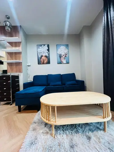 Stylish living room with modern blue sofa and chic decor