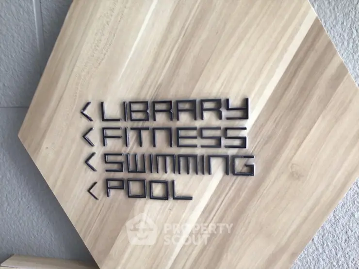 Modern signage for library, fitness, and swimming pool in a stylish building.