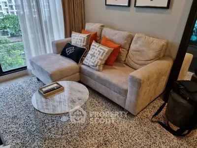 Stylish living room with cozy beige sofa and modern marble coffee table, perfect for relaxation.