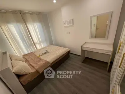 Cozy bedroom with modern decor and ample natural light