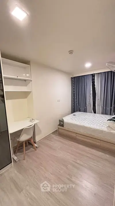 Modern bedroom with built-in desk and cozy bed, featuring elegant curtains and ample storage space.
