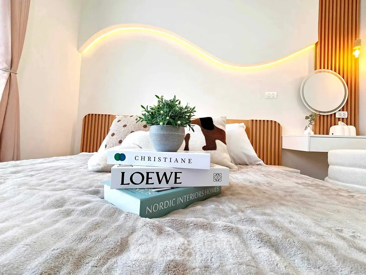 Luxurious bedroom with modern decor and stylish lighting, featuring cozy bedding and elegant design elements.