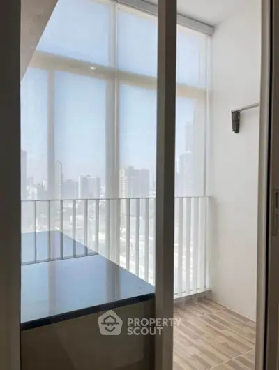 Bright balcony with city view and modern design, perfect for relaxation.