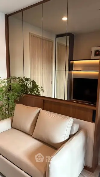 Modern living room with sleek design and mirrored wall panels