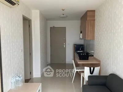 Modern apartment interior with sleek kitchen and cozy living area, perfect for urban living.