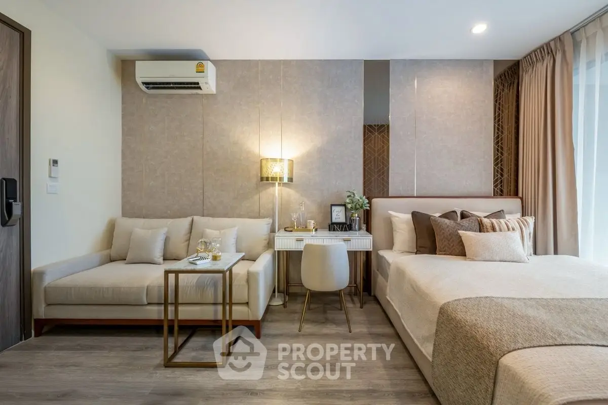 Luxurious studio apartment with elegant decor and cozy ambiance, featuring a stylish bed and comfortable seating area.