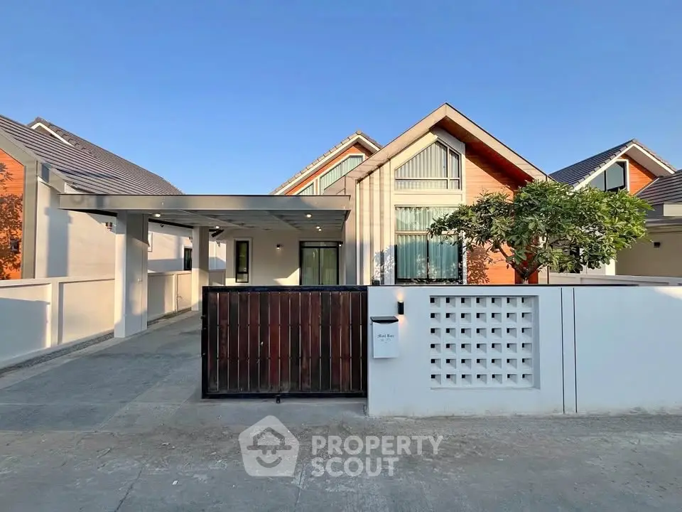 Modern single-story house with sleek design and spacious driveway in a serene neighborhood.