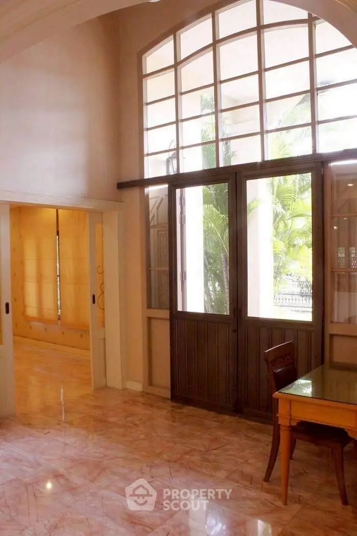 Elegant entrance with large windows and marble flooring in luxurious home