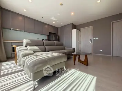 Spacious modern living room with sleek furniture and abundant natural light