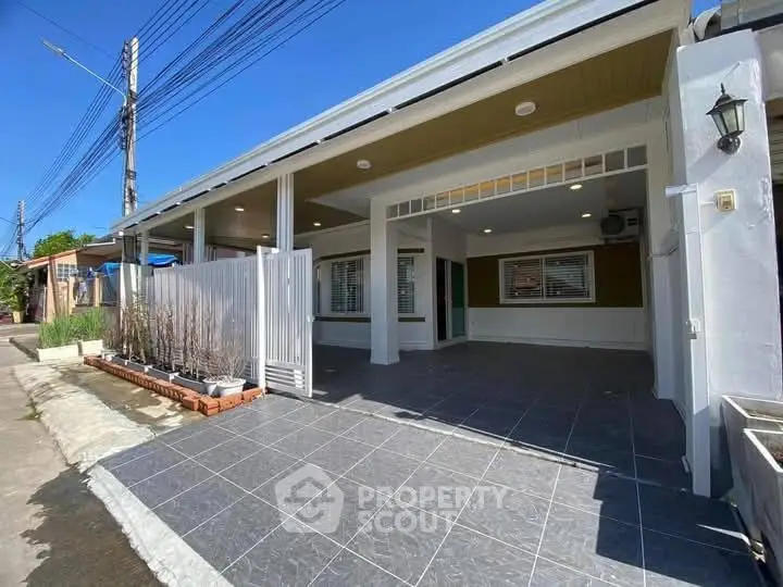 Charming single-story home with spacious covered driveway and modern exterior design.