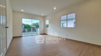 Spacious empty room with large windows and balcony access, perfect for customization.