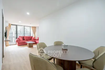 Spacious living room with modern dining area and large windows for natural light.