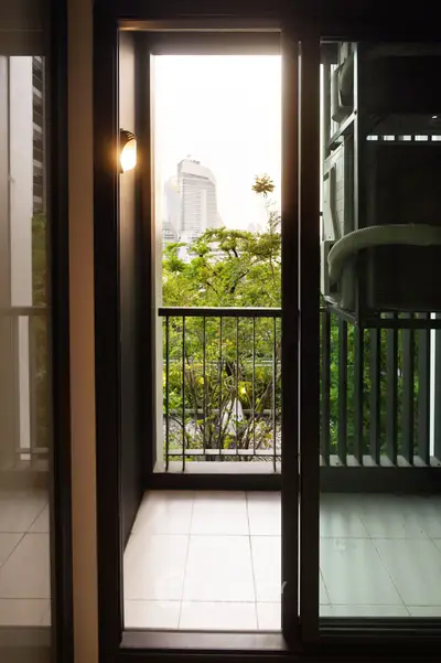 Charming balcony with city view, perfect for relaxation and enjoying urban greenery.