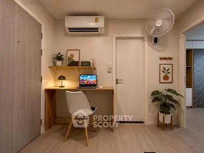 Modern study nook with desk, chair, and wall-mounted fan in cozy apartment interior.
