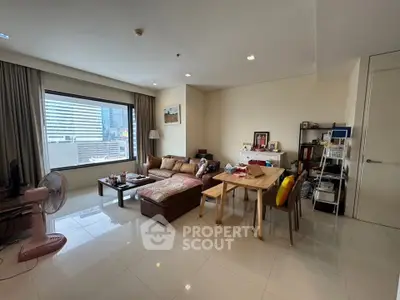 Spacious living room with modern decor and large window view