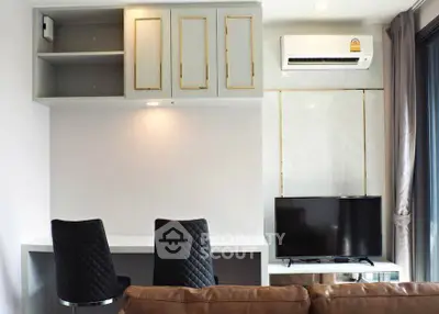 Modern living room with stylish furniture and wall-mounted TV