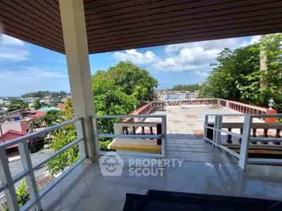Spacious balcony with stunning panoramic view of lush greenery and cityscape
