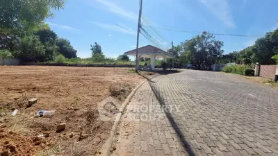 Spacious plot with paved road and gazebo, ideal for development