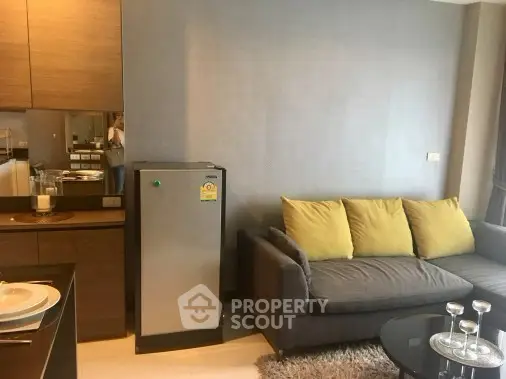 Modern living room with cozy sofa and compact kitchen area