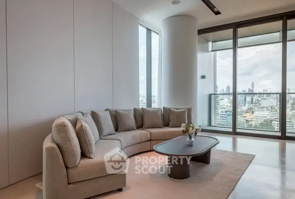 Luxurious living room with panoramic city view and modern decor.