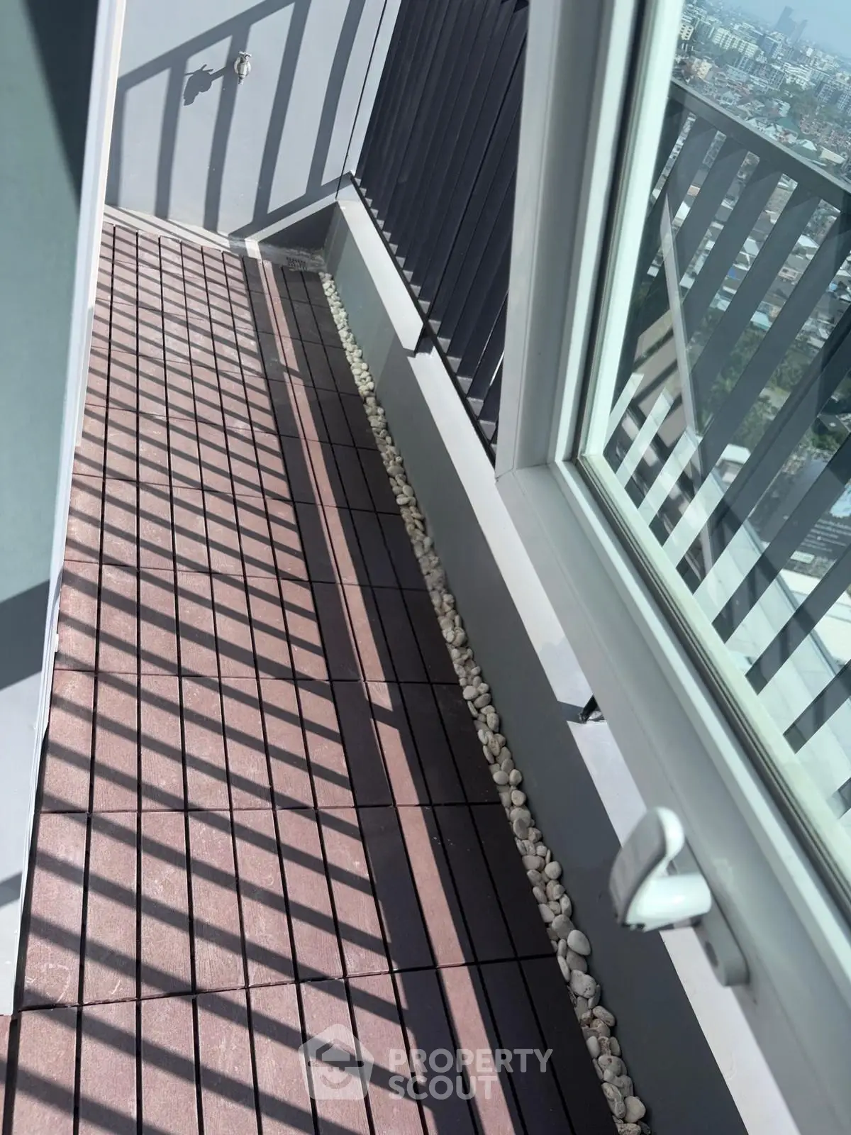 Stylish balcony with modern railing and city view, perfect for relaxation and enjoying the skyline.