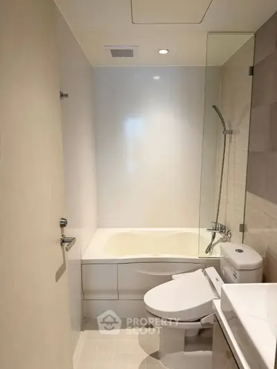 Modern bathroom with sleek design featuring a bathtub and contemporary fixtures.