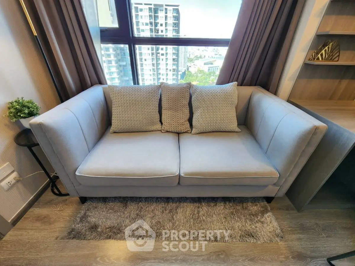 Modern living room with cozy sofa and city view from large window