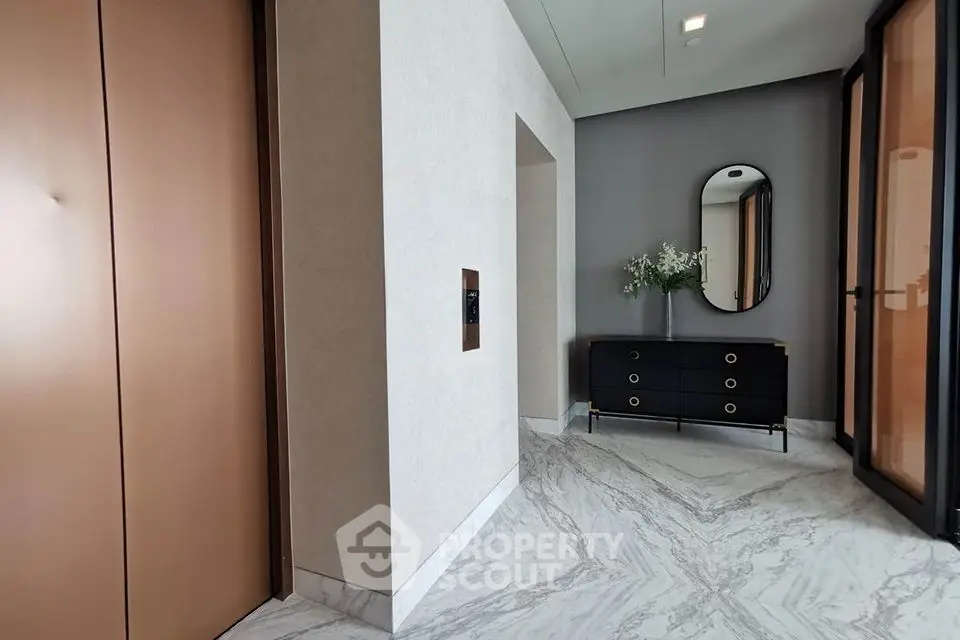 Elegant apartment entrance with modern elevator and stylish decor