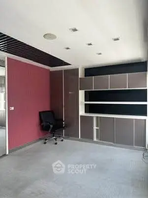 Spacious office room with modern shelving and sleek design