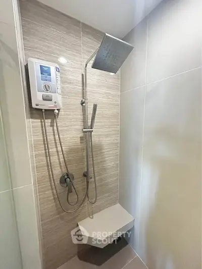 Modern bathroom with sleek shower and water heater in stylish apartment.