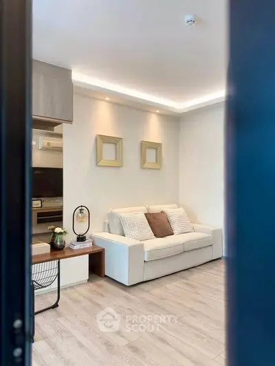 Modern living room with cozy sofa and stylish decor in a contemporary apartment.