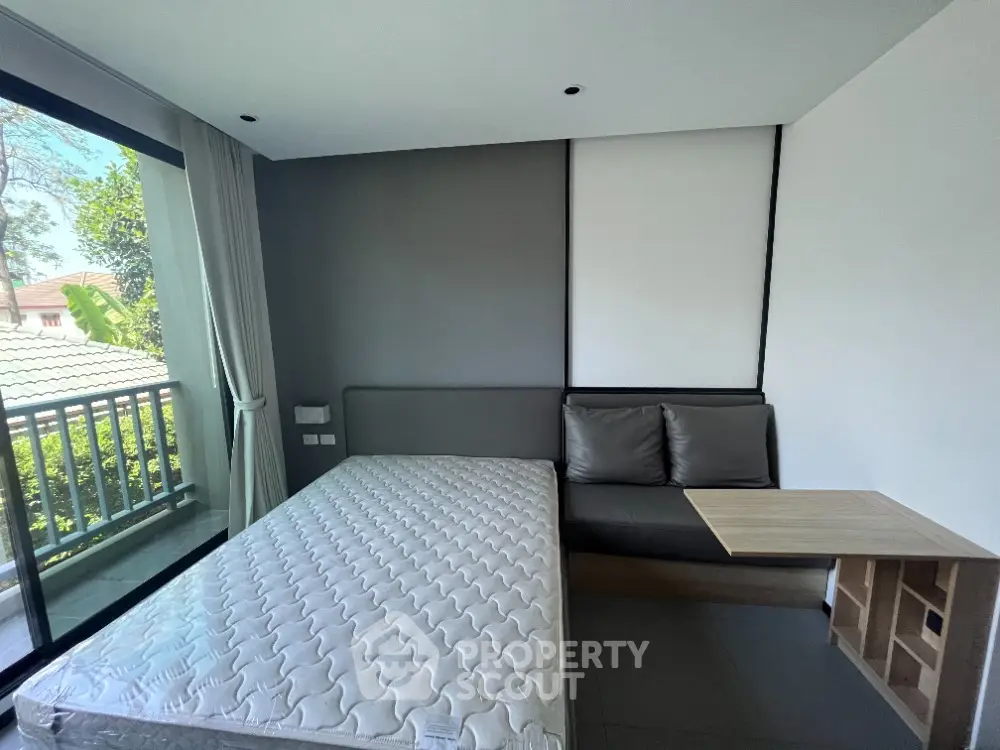 Modern bedroom with balcony view and minimalist decor