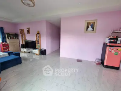 Spacious living room with modern decor and vibrant pink walls