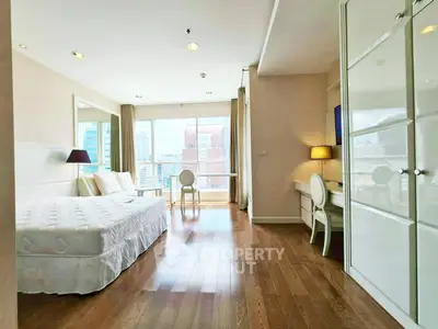 Spacious bedroom with city view, wooden flooring, and elegant furnishings in a modern apartment.
