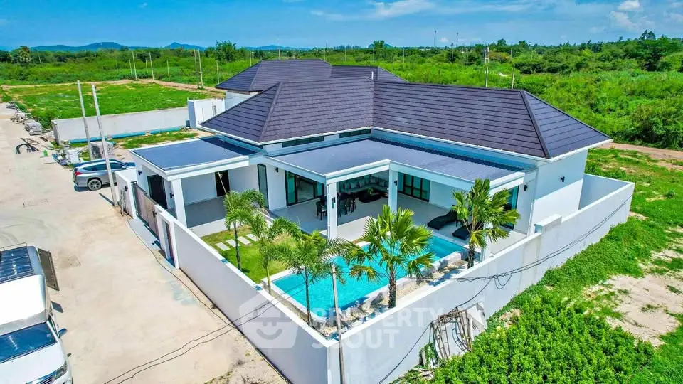 Luxurious modern villa with private pool and lush greenery, perfect for serene living.