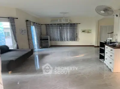 Spacious living room with modern decor and large windows for natural light.