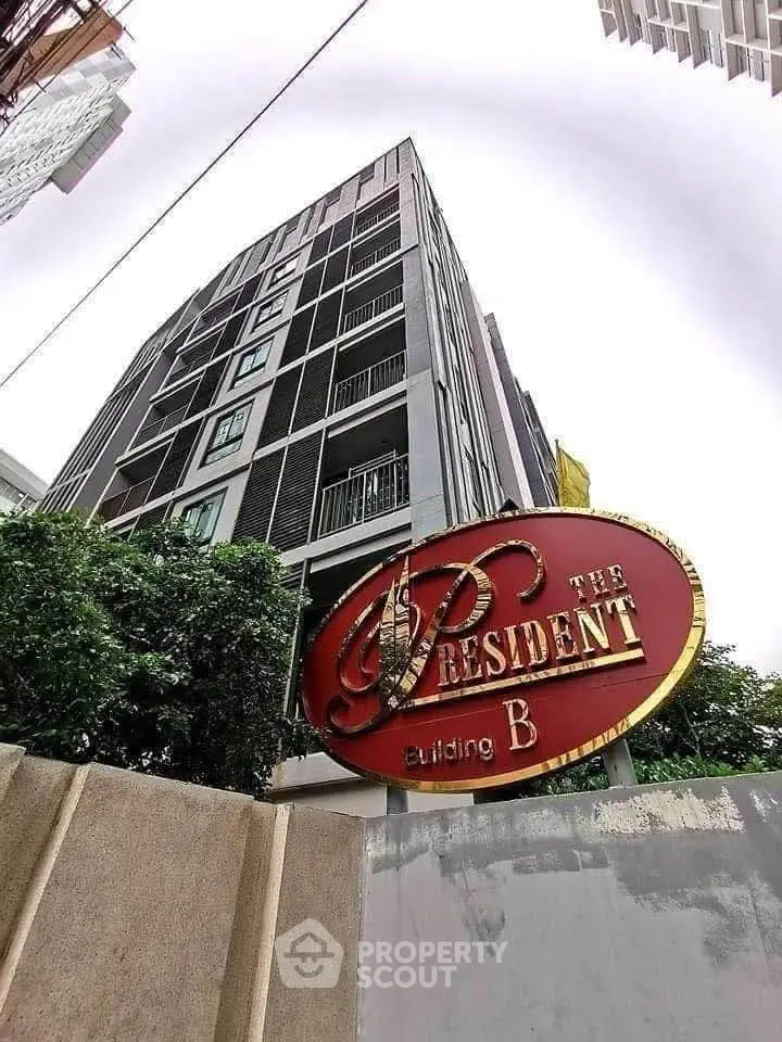 Modern residential building exterior with prominent signage, showcasing urban living at The President Building B.